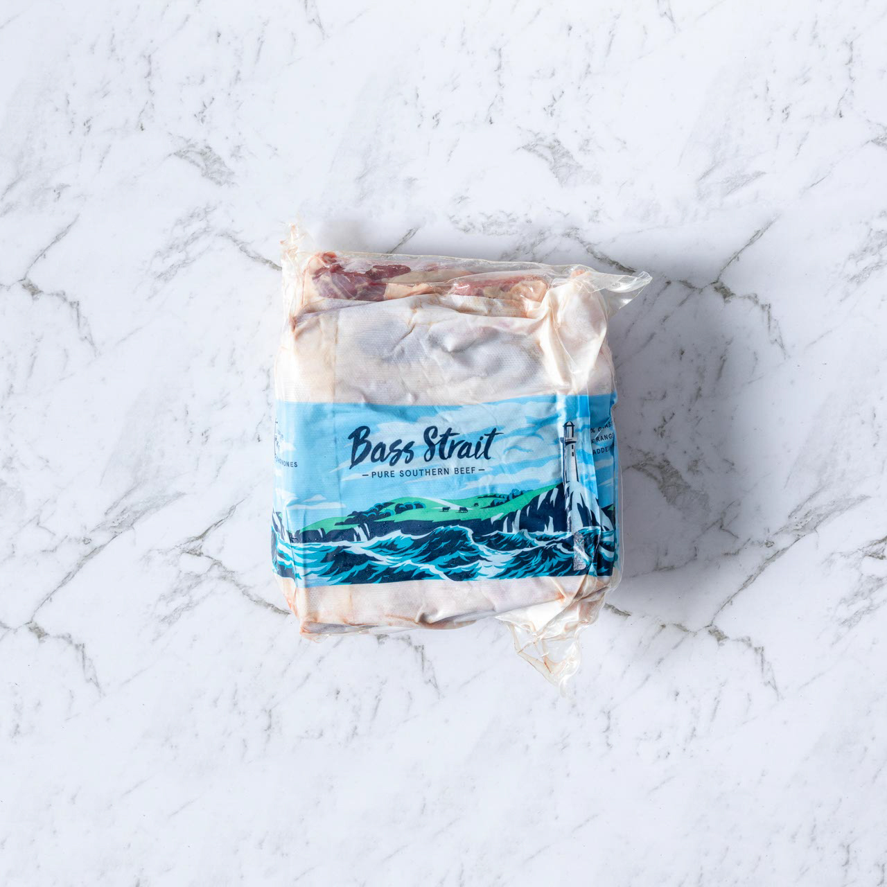 Packaged raw beef on marble background.