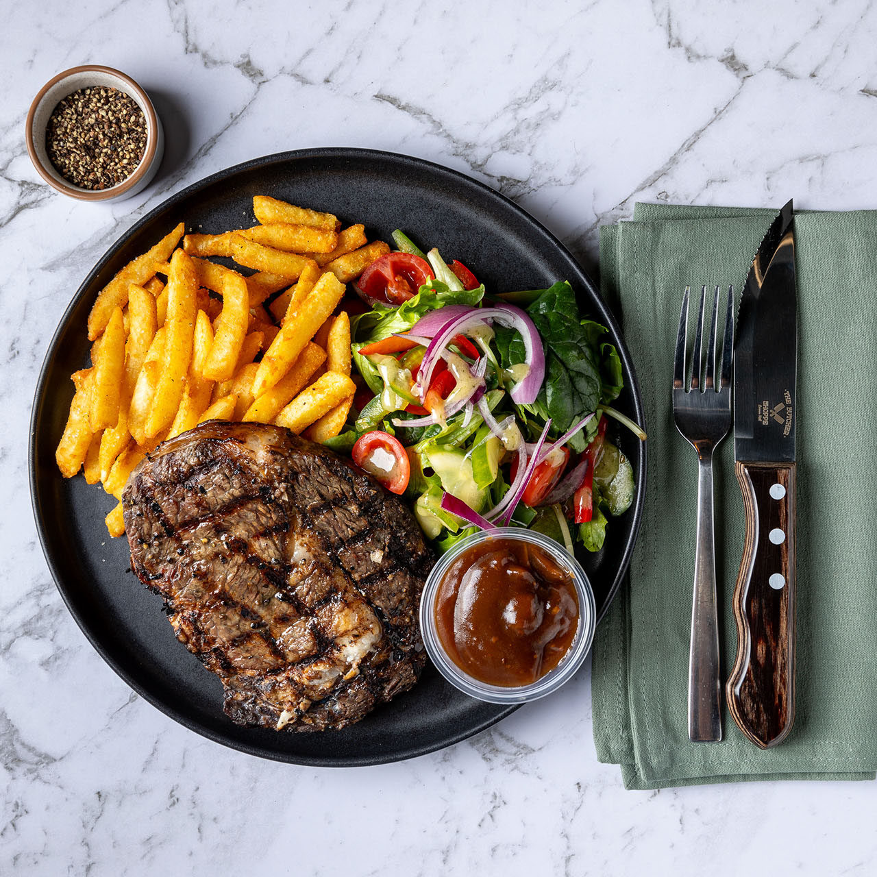 Cooked steak meal. Top-down plating.